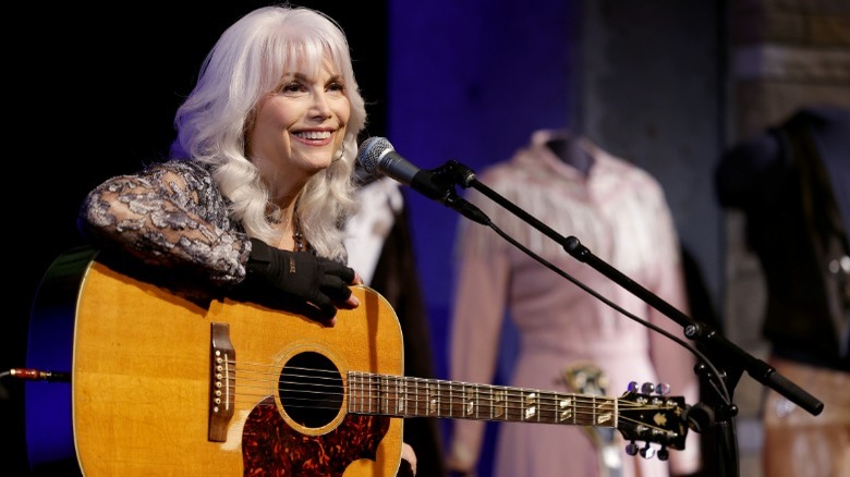 Emmylou Harris onstage holding guitar