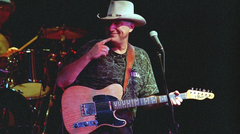 Jerry Jeff Walker onstage playing guitar