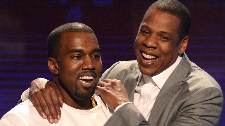 Kanye West and Jay-Z laughing on stage