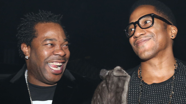 Busta Rhymes and Q-Tip smiling at each other