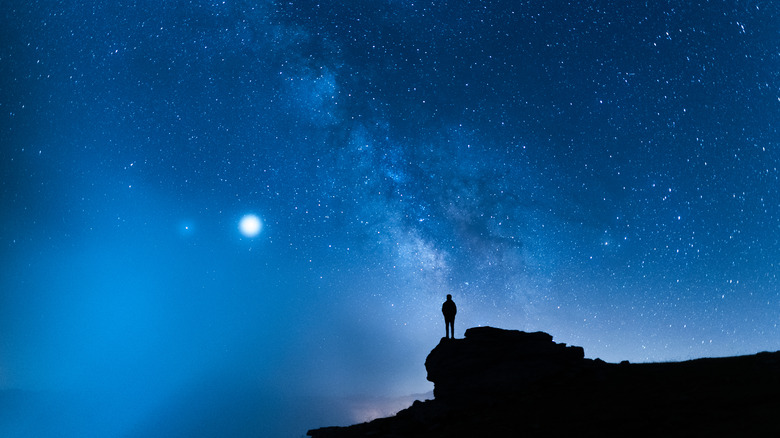 Person standing alone under the stars