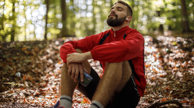 guy sitting in the woods