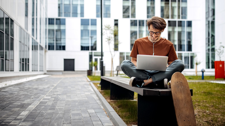 guy using a laptop outside