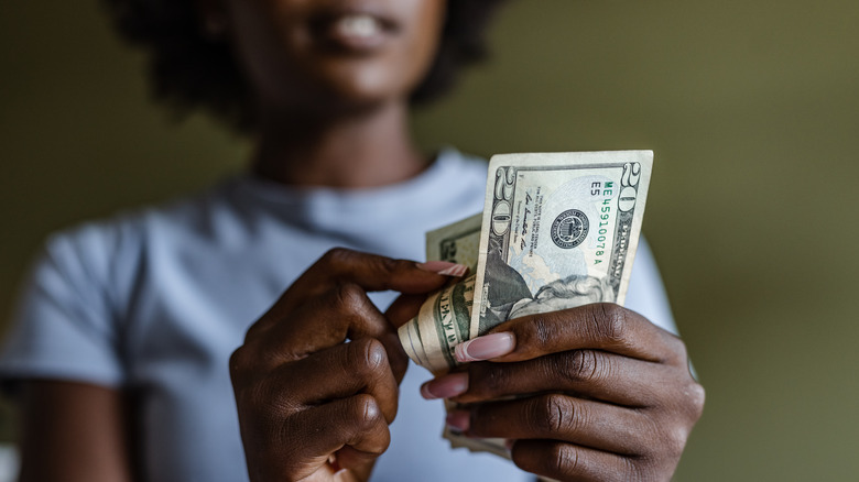 person paying counting cash