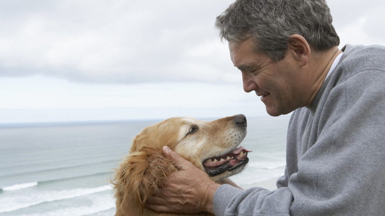 man with dog on the beach