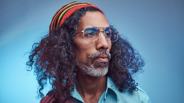 African Rastafarian male against blue background