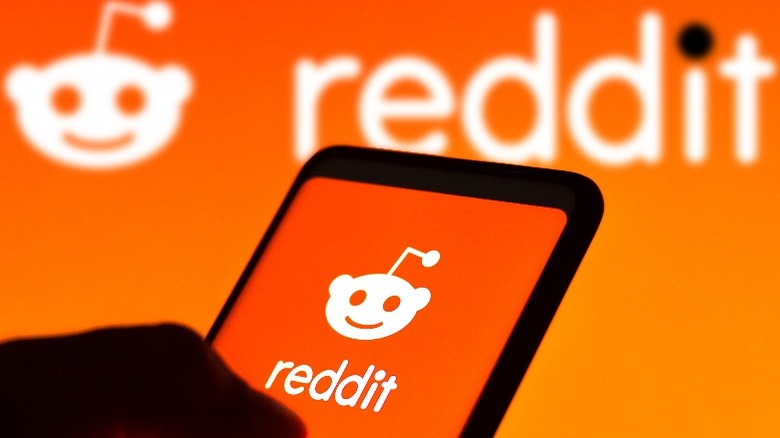 Reddit logo on phone and background