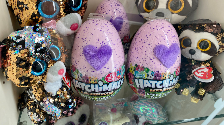 Hatchimal eggs and furry toys on shelf