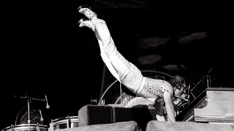 Elton John does piano handstand onstage 