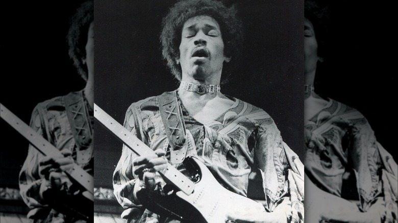 Jimi Hendrix playing guitar onstage