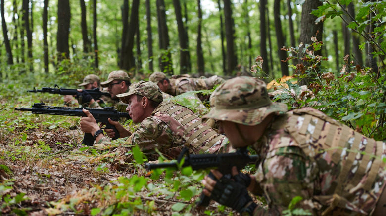 Prone soldiers lining up shots