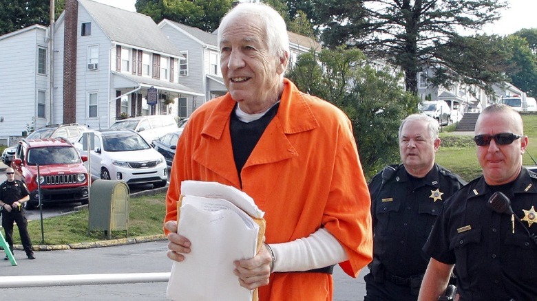 Jerry Sandusky walking with police