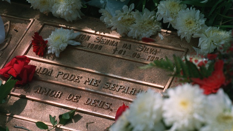 ayrton senna gravestone with flowers