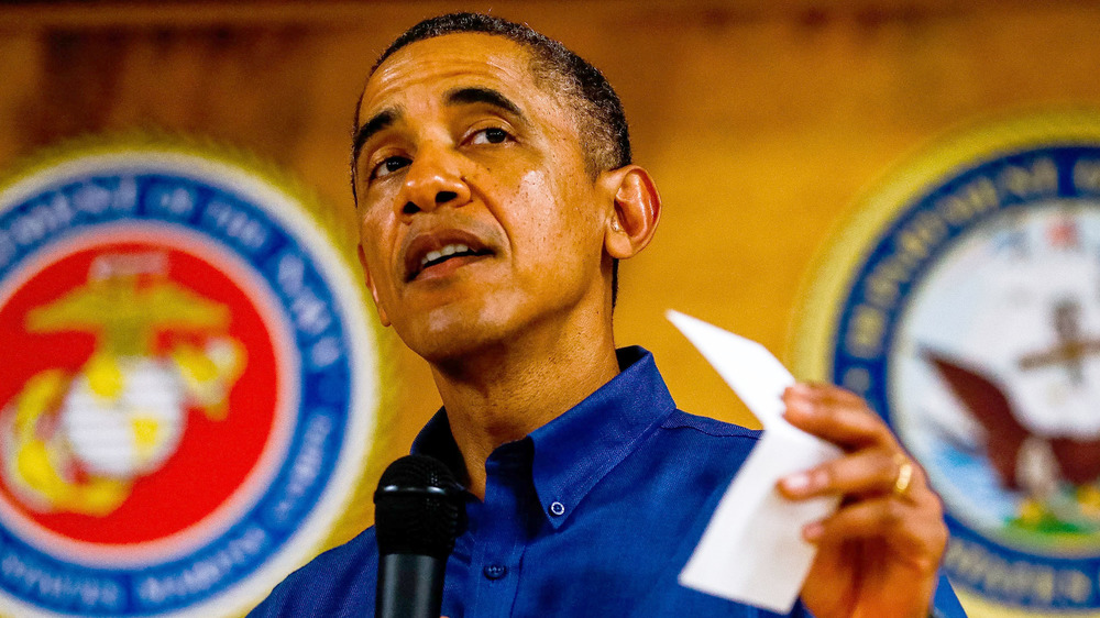 Barack Obama speaking with paper in his hand