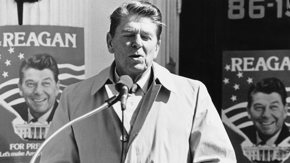 Ronald Reagan, eyes closed in front of mic