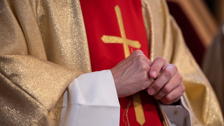 priest hands clasped