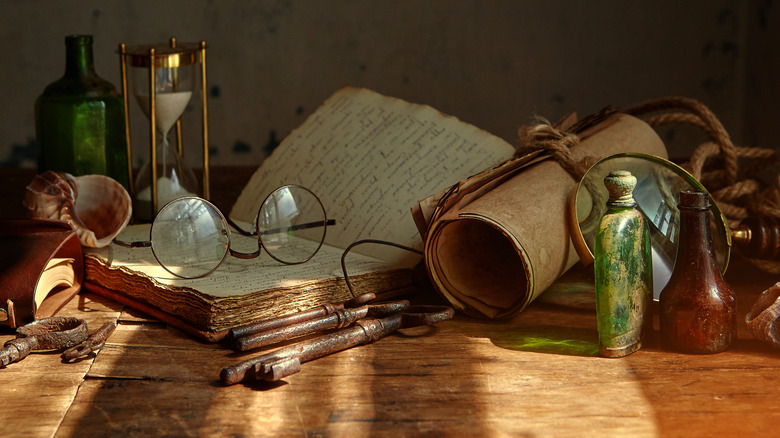 table filled old books medicinal bottles