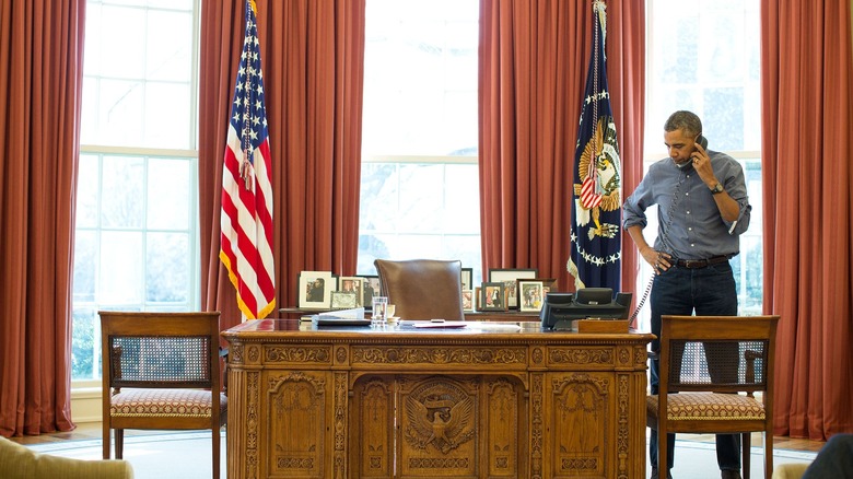 President Barack Obama on the phone in the Oval Office