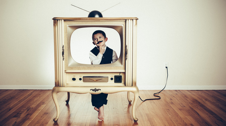 kid on a vintage television set