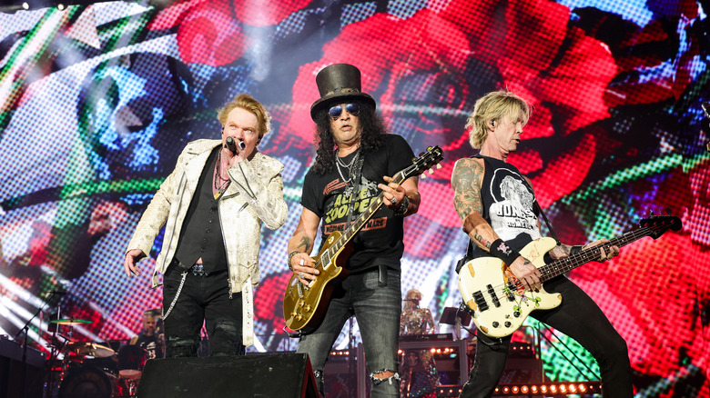 Axl Rose, Slash, and Duff McKagan playing live