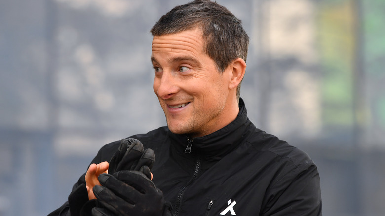 Bear Grylls holding a glove