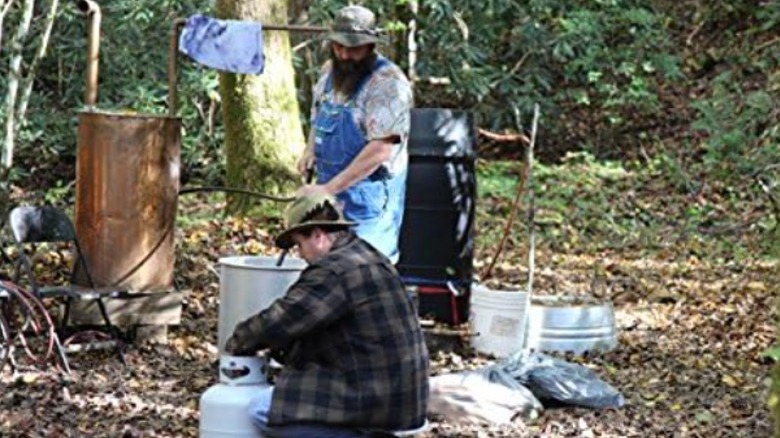 in the woods cooking moonshine