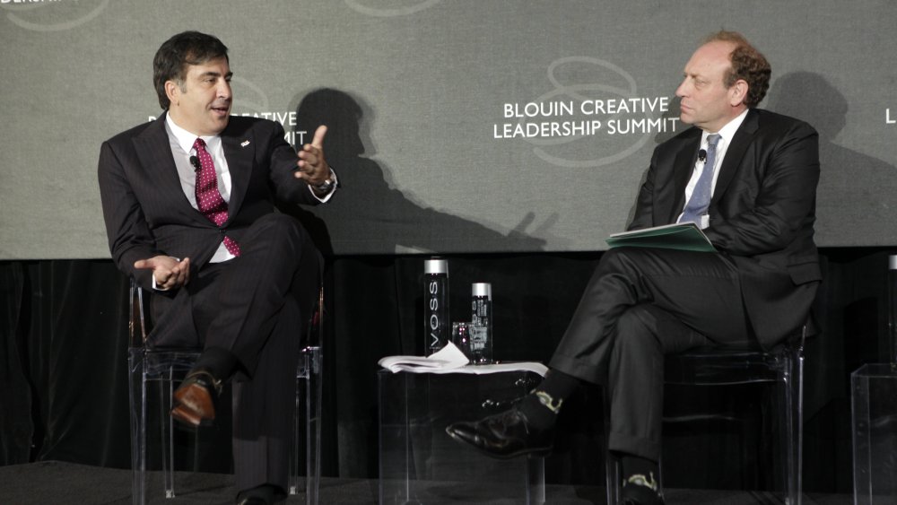 Michael Oreskes (right) on stage at an Associated Press leadership event with the former President of Georgia (left)