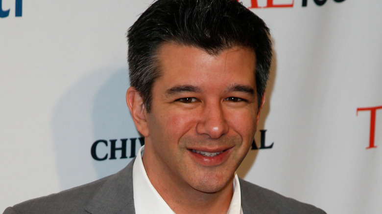 Travis Kalanick squinting at a photo opp