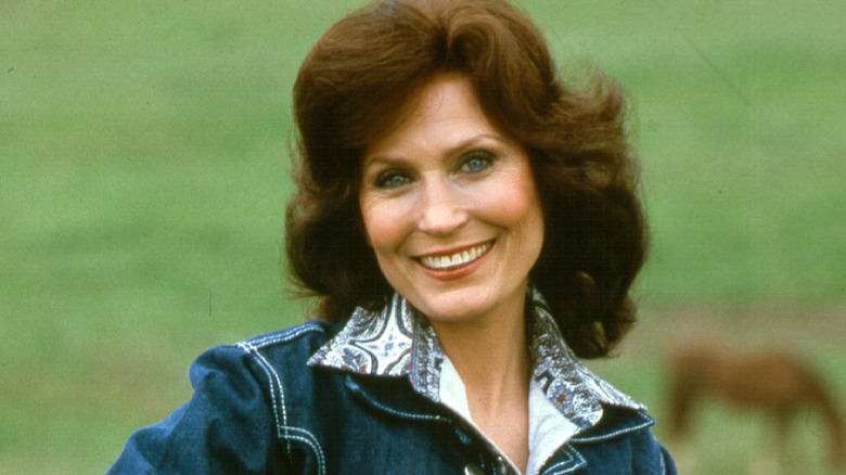 Loretta Lynn posing on farm