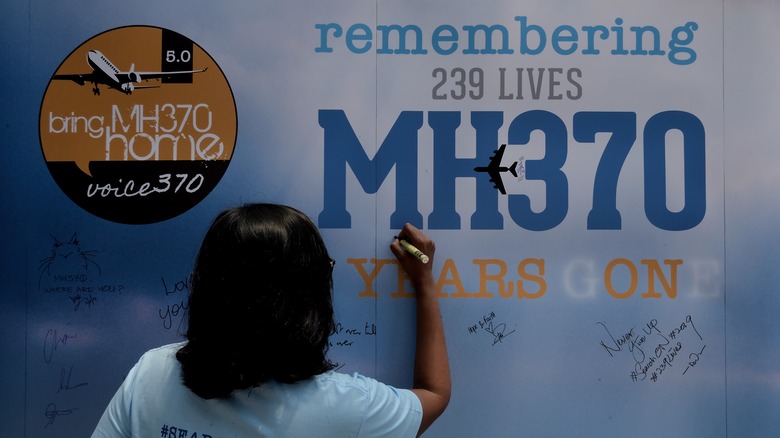 writing on a memorial message board for MH370