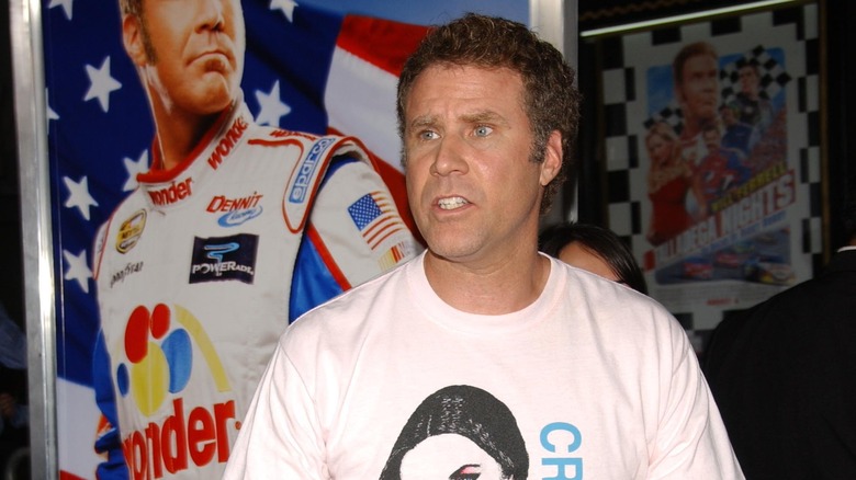 Will Ferrell posing near his movie poster