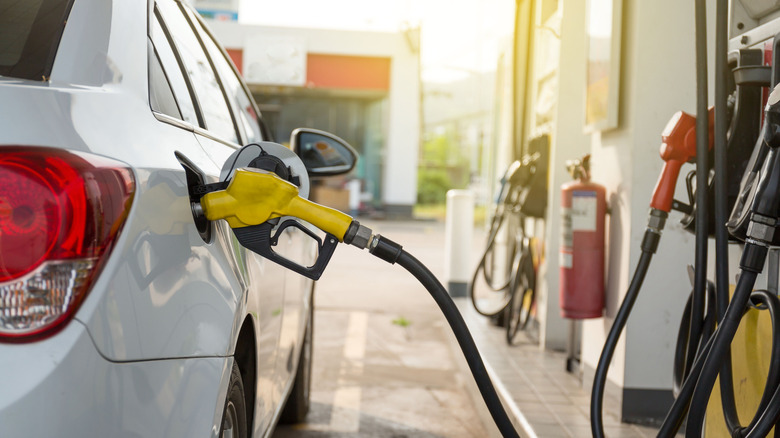 Gas pump sticking out of car