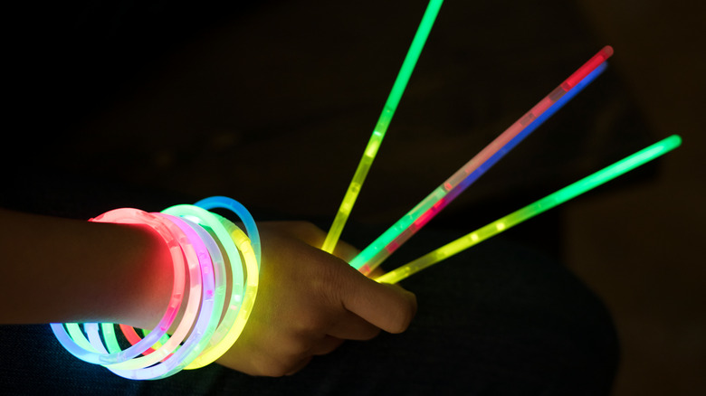 person holding glow sticks