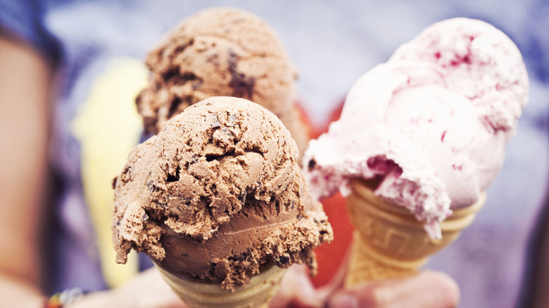 Three friends holding ice cream cones