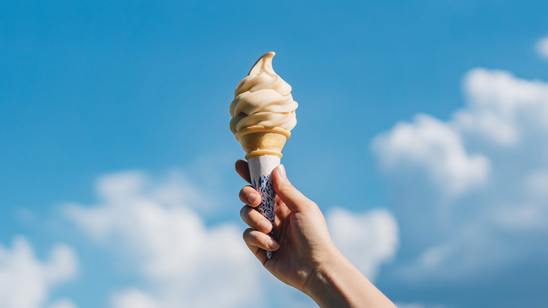 Ice cream coned raised to sky