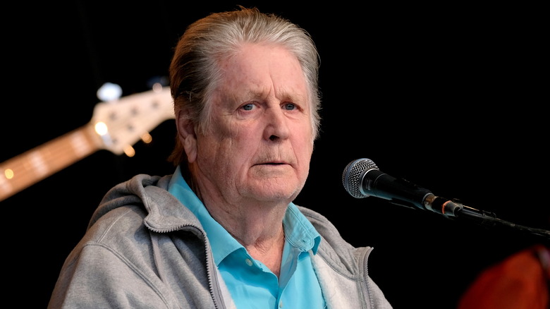 Brian Wilson on stage with microphone