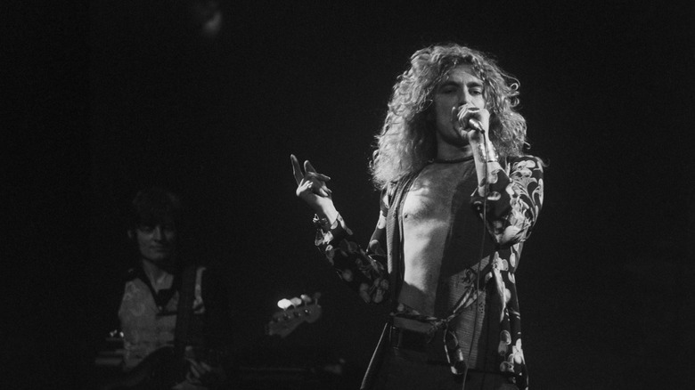 Robert Plant of Led Zeppelin performing with John Paul Jones in the background