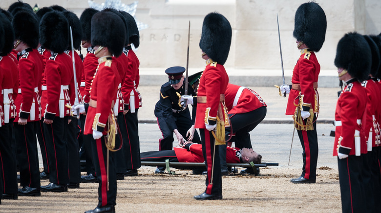 Guard placed on stretcher