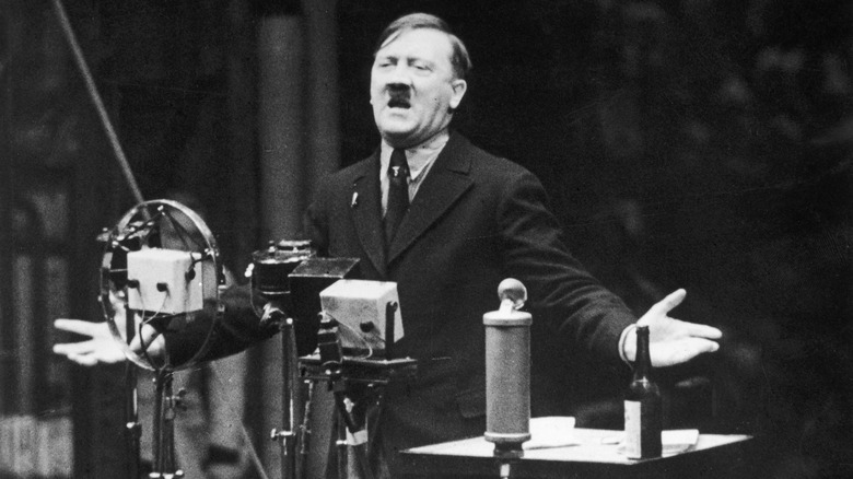 Adolf Hitler at podium arms out