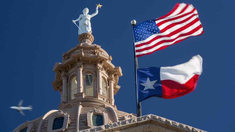 Texas capitol building flying flags