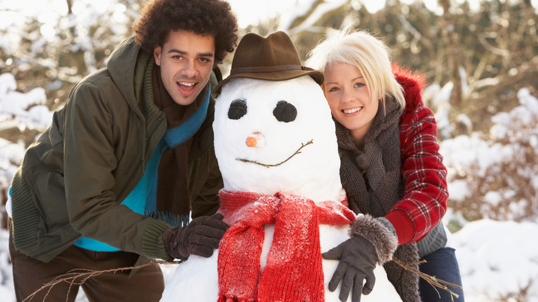 couple building a snowman