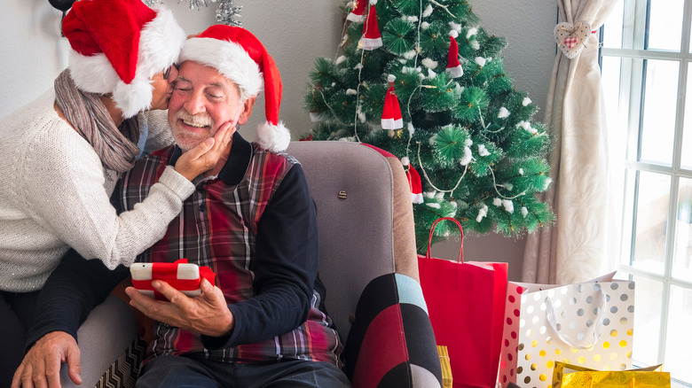 couple kissing by the christmas tree