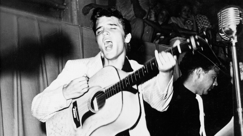 Elvis Presley singing with guitar