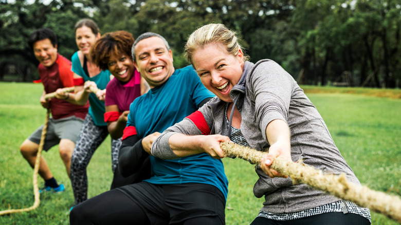 Team playing tug of war