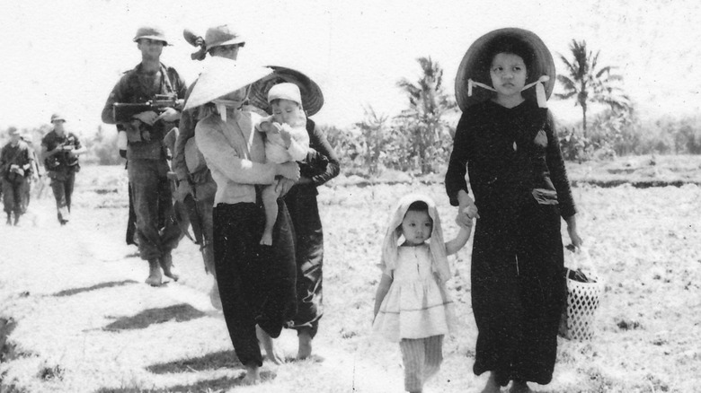 Vietnamese civilians alongside soldiers