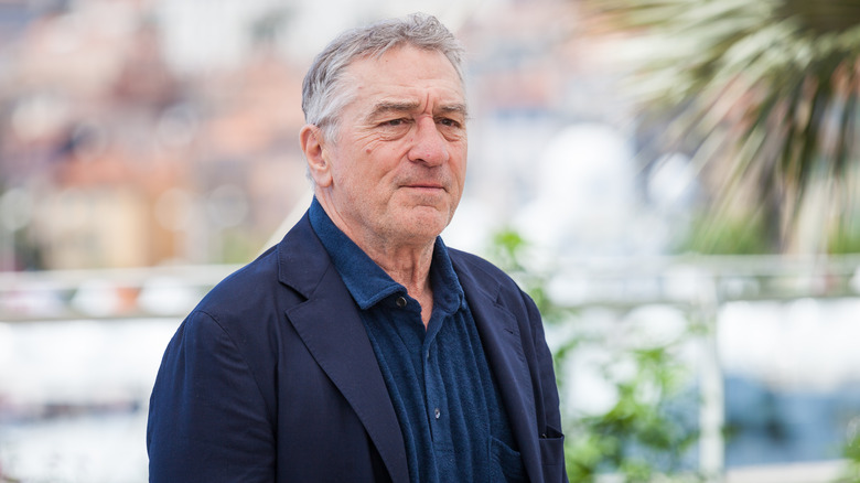 Robert De Niro outside dark blue shirt suit