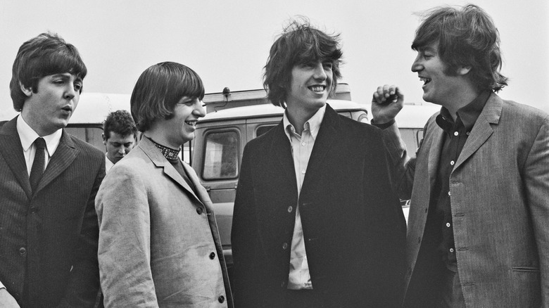 The Beatles smiling and laughing