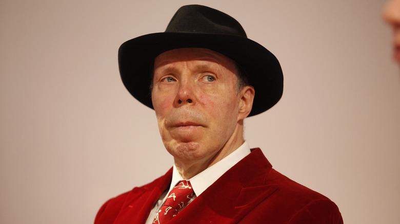 Gunther von Hagens with red jacket and black hat