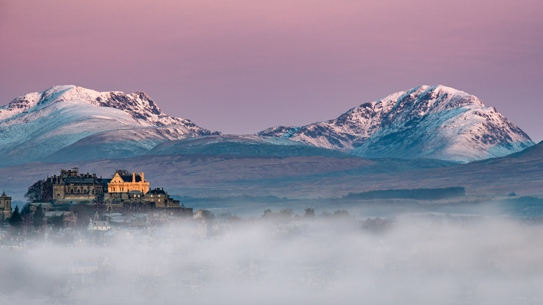 Snowy mountains with buildings in foreground