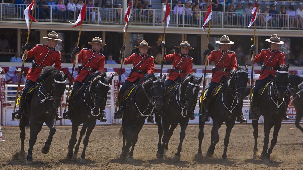 Royal Canadian Mounted Police perform intricate moves to music while riding horses during opening day ceremonies on July 6, 2012 in Calgary, Canada. 